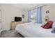 Cozy bedroom with light blue walls, wood-look flooring, and a window with plenty of natural light at 357 Cabo Loop, Myrtle Beach, SC 29588