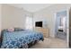 Bright bedroom featuring a blue patterned bedspread, dresser with a television, and natural light at 357 Cabo Loop, Myrtle Beach, SC 29588