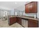 Well-equipped kitchen featuring granite counters, stainless steel dishwasher, and dark wood cabinets at 357 Cabo Loop, Myrtle Beach, SC 29588