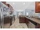 Open kitchen with stainless steel appliances, granite countertops, and views into the dining area at 357 Cabo Loop, Myrtle Beach, SC 29588