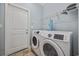 Functional laundry room with modern washer and dryer units and overhead shelving for storage at 357 Cabo Loop, Myrtle Beach, SC 29588