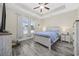 Bright main bedroom with tray ceiling, ceiling fan, neutral walls and light wood furniture at 357 Cabo Loop, Myrtle Beach, SC 29588