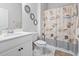 Bright bathroom featuring white cabinets, marble floors, and beach-themed shower curtains at 360 Cattle Drive Circle, Myrtle Beach, SC 29588