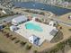 Aerial view of a community pool surrounded by lush landscaping and neighborhood homes at 360 Cattle Drive Circle, Myrtle Beach, SC 29588