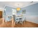 Cozy dining area with white table, blue walls, and cabinet at 404 72Nd Ave. N # 203, Myrtle Beach, SC 29572