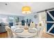 The dining area features a white table, sliding barn door, and modern lighting at 404 72Nd Ave. N # 203, Myrtle Beach, SC 29572