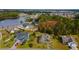 Aerial shot showcases the property, neighboring homes, community lake, and lush landscaping from above at 405 Palo Verde Dr., Myrtle Beach, SC 29579