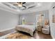 A cozy bedroom features a tray ceiling, coastal decor, and plentiful natural light at 405 Palo Verde Dr., Myrtle Beach, SC 29579