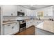 A modern kitchen showcasing granite countertops, stainless appliances, and sleek white cabinets at 405 Palo Verde Dr., Myrtle Beach, SC 29579