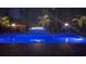 Nighttime view of a sparkling pool with ambient lighting, creating a tranquil and inviting atmosphere at 405 Palo Verde Dr., Myrtle Beach, SC 29579