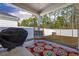 Cozy covered patio featuring stylish outdoor chair, grill, and colorful rug at 4092 Bayhill St., Myrtle Beach, SC 29579