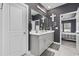 Bathroom with a dual sink vanity, large mirror, and open doorway to the main bedroom in background at 4092 Bayhill St., Myrtle Beach, SC 29579