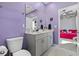 Stylish bathroom with double vanity, purple walls, large mirror, and view of a unique bedroom at 4092 Bayhill St., Myrtle Beach, SC 29579