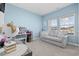 Cozy bedroom with a comfortable gray sofa, globe, desk, and window bringing in natural light at 4092 Bayhill St., Myrtle Beach, SC 29579