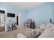 Bedroom features light blue walls, a gray sofa, and a desk by the window for a calm and bright space at 4092 Bayhill St., Myrtle Beach, SC 29579