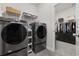 Well-organized laundry room with gray washer and dryer, leading to a spacious walk-in closet at 4092 Bayhill St., Myrtle Beach, SC 29579