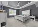 Relaxing main bedroom with a tray ceiling, large windows, and a comfortable queen-sized bed at 4092 Bayhill St., Myrtle Beach, SC 29579