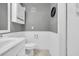 Bright powder room featuring beadboard, fresh white fixtures, a ceramic tile floor and neutral decor at 415 Ocean Creek Dr. # 2359, Myrtle Beach, SC 29572