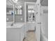 Clean, gray-themed bathroom with a vanity, sink, and well-lit mirror, leading to the shower area at 415 Ocean Creek Dr. # 2359, Myrtle Beach, SC 29572