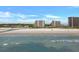 Stunning view of a beach with condos and houses near the beach and waves crashing onto shore at 415 Ocean Creek Dr. # 2359, Myrtle Beach, SC 29572