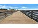 Scenic view down a wooden boardwalk with wooden rails, leading to the beach and the ocean at 415 Ocean Creek Dr. # 2359, Myrtle Beach, SC 29572