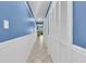 Spacious hallway boasts pristine white closet doors against vibrant blue walls, plus tile flooring at 415 Ocean Creek Dr. # 2359, Myrtle Beach, SC 29572