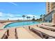 Resort style pool with sun loungers and palm trees, perfect for relaxation and enjoying the sun at 415 Ocean Creek Dr. # 2359, Myrtle Beach, SC 29572