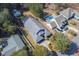 Stunning aerial view of a home featuring a private pool, screened in porch, and lush landscaping at 4244 Luck Ave., Little River, SC 29566