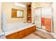 This bathroom boasts a tub with wood paneling and glass shower, providing a relaxing and refreshing experience at 4244 Luck Ave., Little River, SC 29566