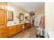 Well-lit bathroom features wooden cabinetry, double sinks, and decorative accents at 4244 Luck Ave., Little River, SC 29566