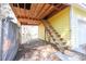 Exterior view of unfinished area beneath garage with stairs and covered storage at 4244 Luck Ave., Little River, SC 29566