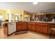 Open concept kitchen with light wood floors, countertops and adjacent to a cozy eating area and a ceiling fan at 4244 Luck Ave., Little River, SC 29566