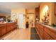 Well-lit kitchen features wooden cabinets, a breakfast bar, and laminate flooring, and a dining area at 4244 Luck Ave., Little River, SC 29566