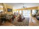 Open and bright living room with hardwood floors, ceiling fan, and sliding glass doors to the patio at 4244 Luck Ave., Little River, SC 29566