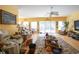 Bright living room with hardwood floors, ceiling fan, and sliding glass doors to outdoor space at 4244 Luck Ave., Little River, SC 29566