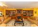 Cozy living room boasts built-in bookshelves, a fireplace, comfortable seating, and decorative area rug at 4244 Luck Ave., Little River, SC 29566