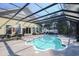 A beautiful enclosed pool surrounded by patio furniture provides a perfect outdoor retreat at 4244 Luck Ave., Little River, SC 29566