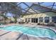 Relaxing pool with a screened enclosure and plenty of seating at 4244 Luck Ave., Little River, SC 29566