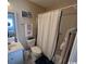 Cozy bathroom with a shower-tub combination, white cabinets, and a decorative mirror at 4305 Rivergate Ln., Little River, SC 29566