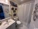 Small bathroom with a vanity sink, toilet, and shower curtain at 4305 Rivergate Ln., Little River, SC 29566