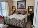 Cozy bedroom featuring a metal frame bed, bedside lamps, and decorative pillows at 4305 Rivergate Ln., Little River, SC 29566