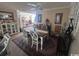 Charming dining area with a modern table, decorative rug, and ample natural light at 4305 Rivergate Ln., Little River, SC 29566