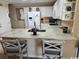 Kitchen featuring a breakfast bar with granite countertops, white cabinets, and stainless steel appliances at 4305 Rivergate Ln., Little River, SC 29566