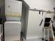 A compact laundry area featuring a stacked washer and dryer set at 4305 Rivergate Ln., Little River, SC 29566