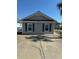 The exterior features a concrete driveway with a two-car garage and dark blue trim at 4340 Grande Harbour Blvd., Little River, SC 29566