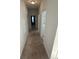 Hallway with neutral carpet leading to bedrooms and laundry room at 4340 Grande Harbour Blvd., Little River, SC 29566