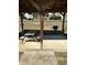 Outdoor picnic area featuring a grill and a wooden picnic table set on a concrete pad under a sheltered structure at 4340 Grande Harbour Blvd., Little River, SC 29566