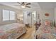 Bedroom featuring two twin beds, window with blinds, and connected bathroom at 4350 Intercoastal Dr. # 1101, Little River, SC 29566