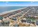 Aerial view of neighborhood with a red pin on the property and partial ocean view at 4601 N Ocean Blvd. # 203, North Myrtle Beach, SC 29582