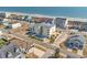 Aerial view of a yellow condo building with pool near the beach and beautiful coastline at 4601 N Ocean Blvd. # 203, North Myrtle Beach, SC 29582